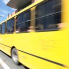 Imagem de um ônibus amarelo em movimento